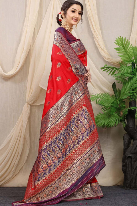 Elegant woman in red Banarasi silk saree with intricate jacquard weaving, styled with a matching blouse piece.