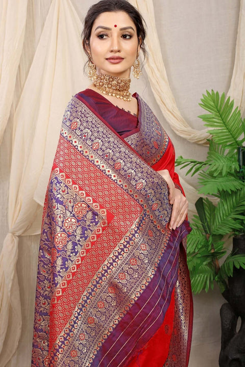 Elegant woman in a red Banarasi silk saree with jacquard weaving, adorned with jewelry and a stylish blouse.